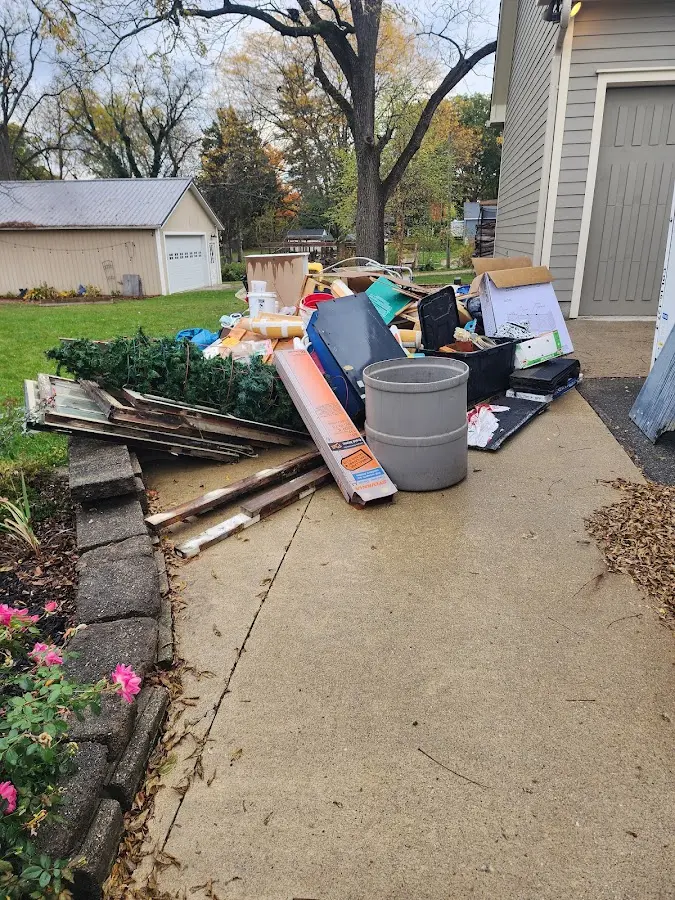 Dumpster being loaded with debris for Roofing Dumpster Rental in Spokane Valley
